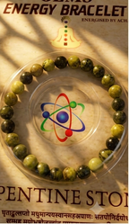 Gems Energy Bracelet packaging with serpentinite stone on a decorative background