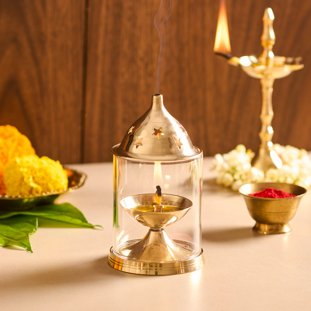 Decorative oil lamp with flowers and other items on a table