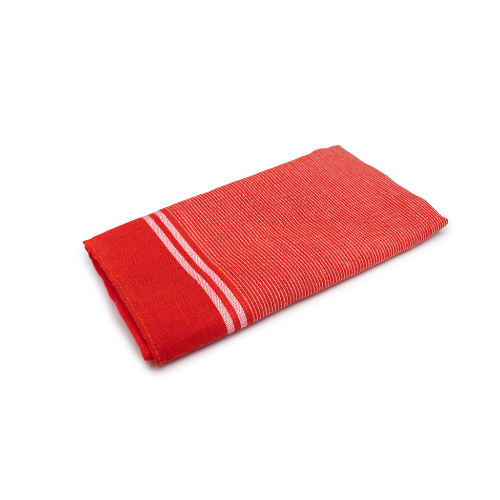 Folded red towel with white stripes on a white background