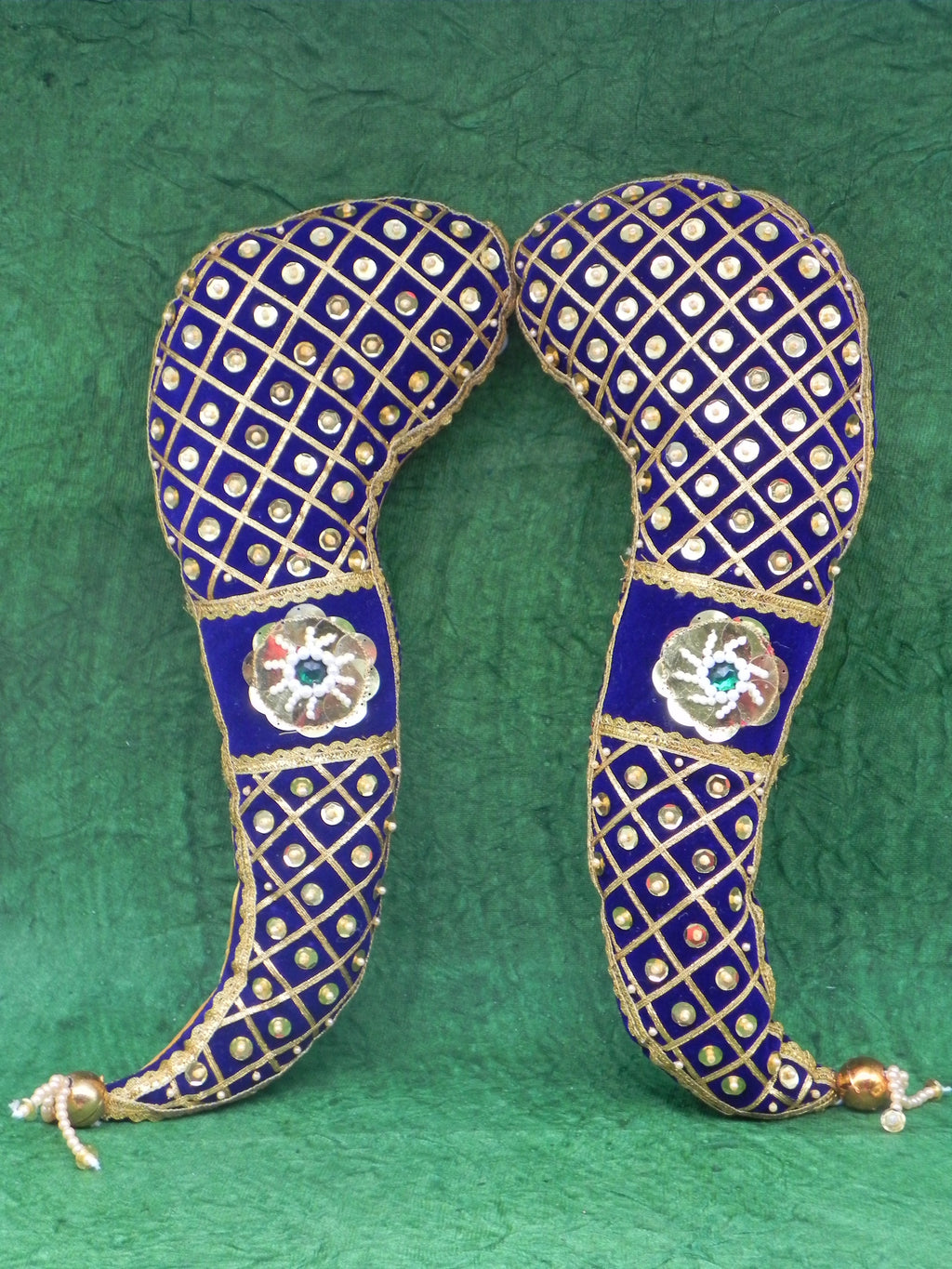 Decorative headband with blue and gold patterns on a green background