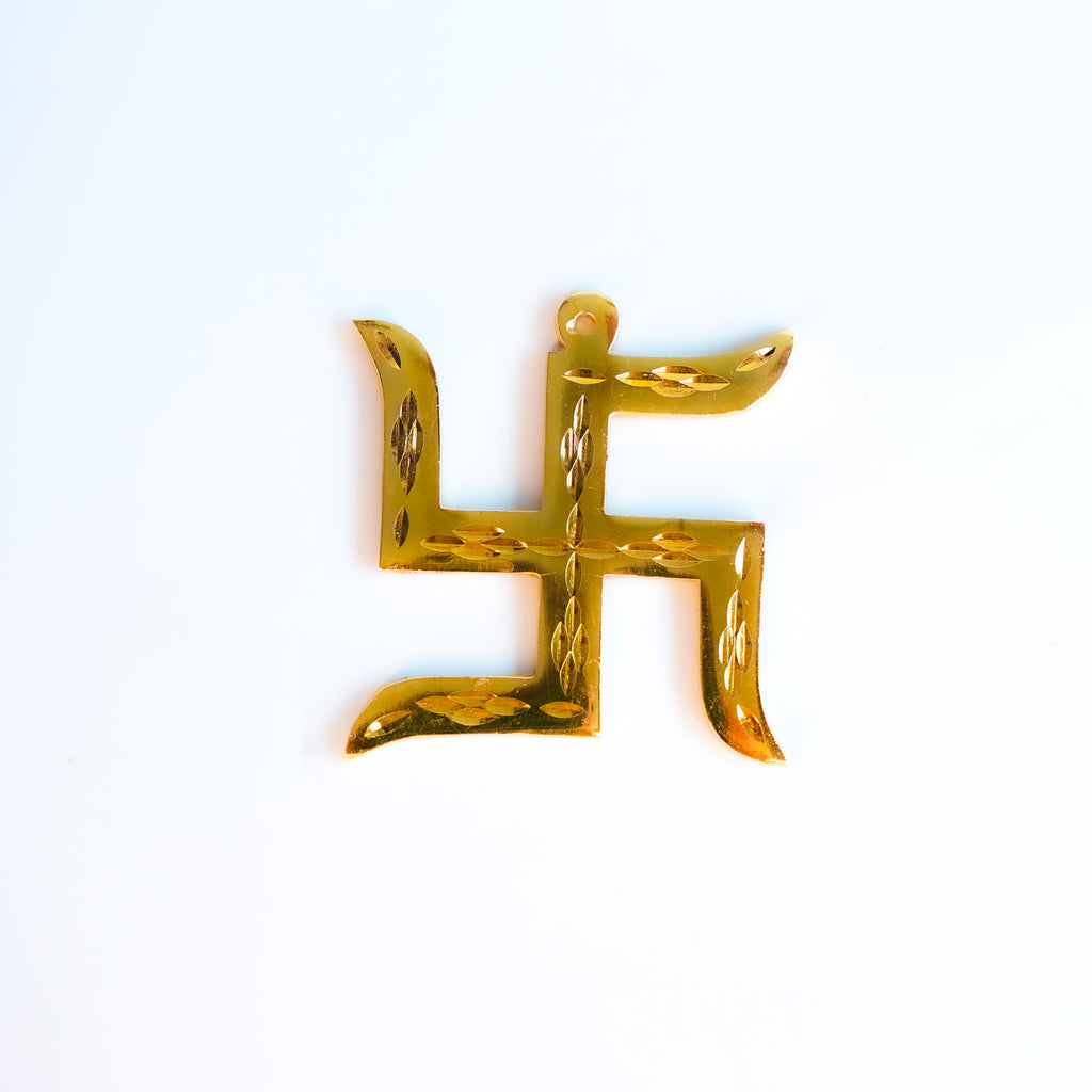 Gold swastika symbol on a white background