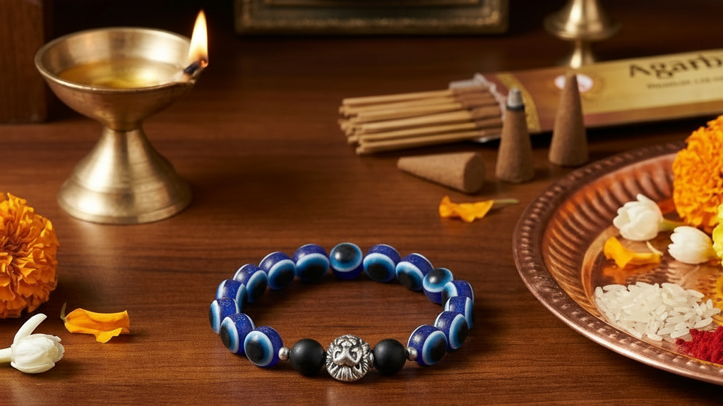Blue beaded bracelet with a lion charm on a wooden surface with decorative items.