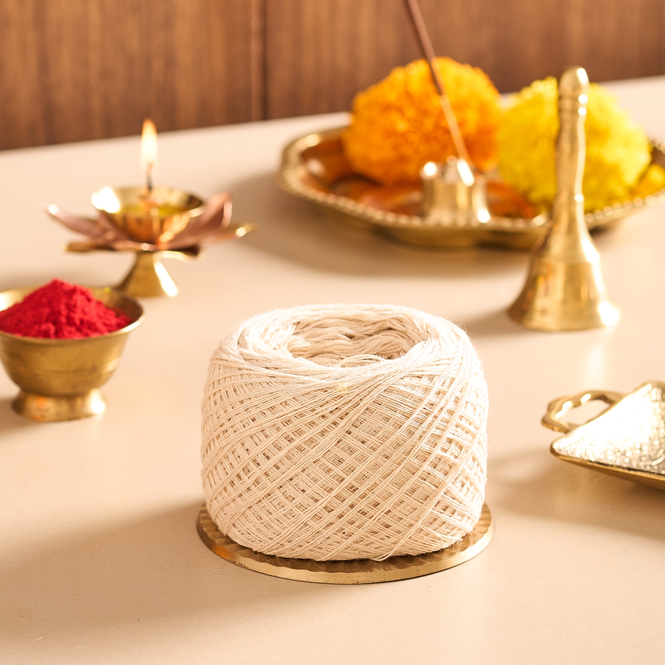 Spool of string on a table with festive decorations in the background