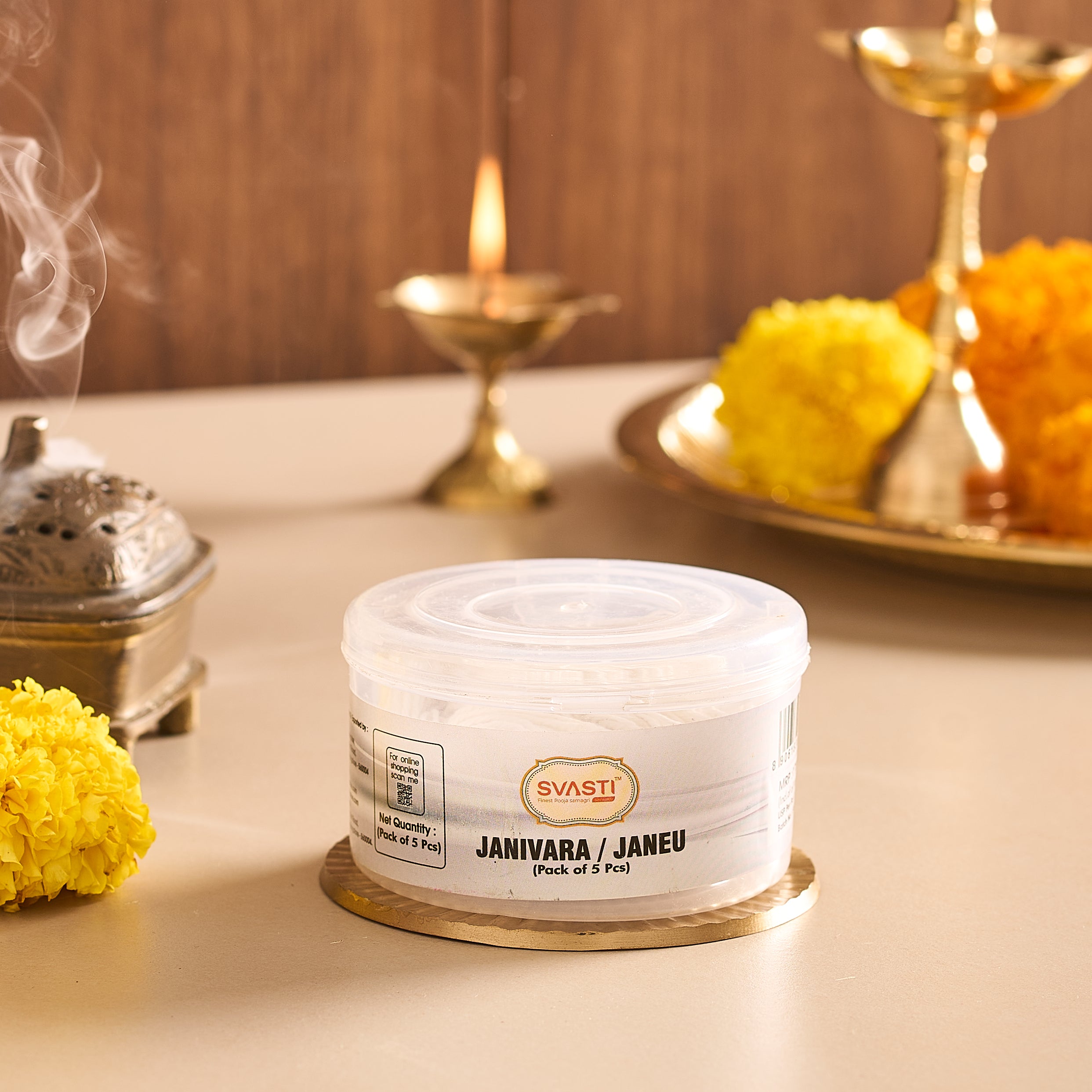 Container of SVASTI Janivara/Janeu on a table with decorative elements