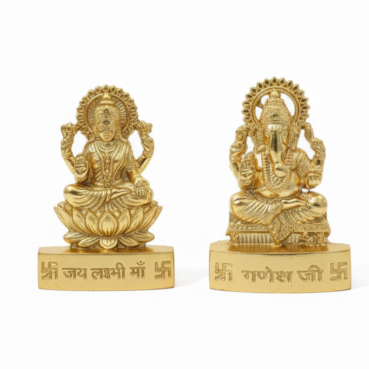 Two gold-colored statues lakshmi and ganesh idols who is Hindu deities on white background