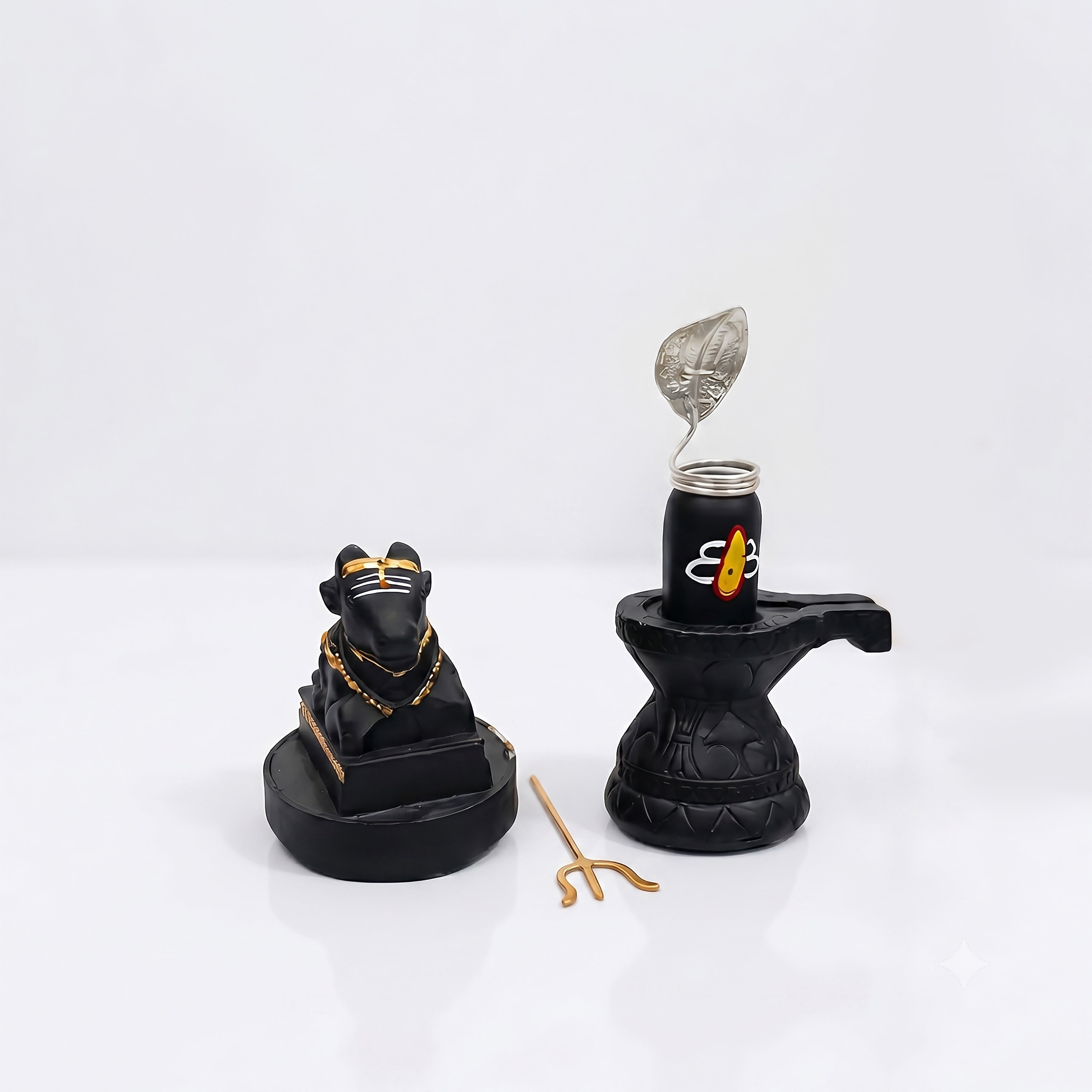 Black and gold decorative items on a white background