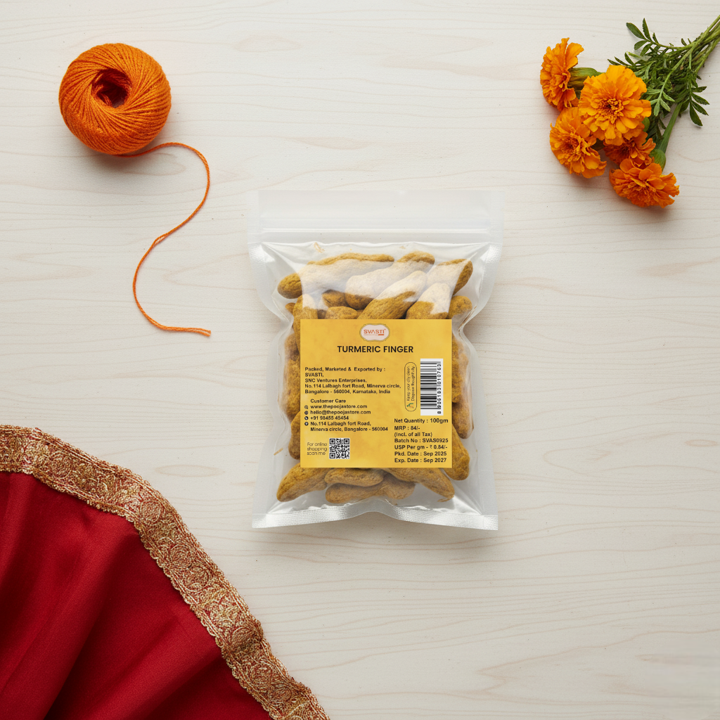 Packaged food item with a yellow label on a light wooden surface, accompanied by an orange yarn ball and marigold flowers.