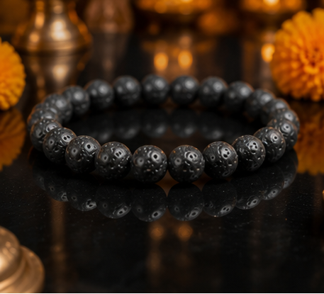 Collage of black beaded bracelets on a marble surface with decorative elements.