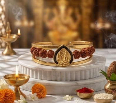 Gold bracelet with maroon stones on a decorative table with candles and flowers