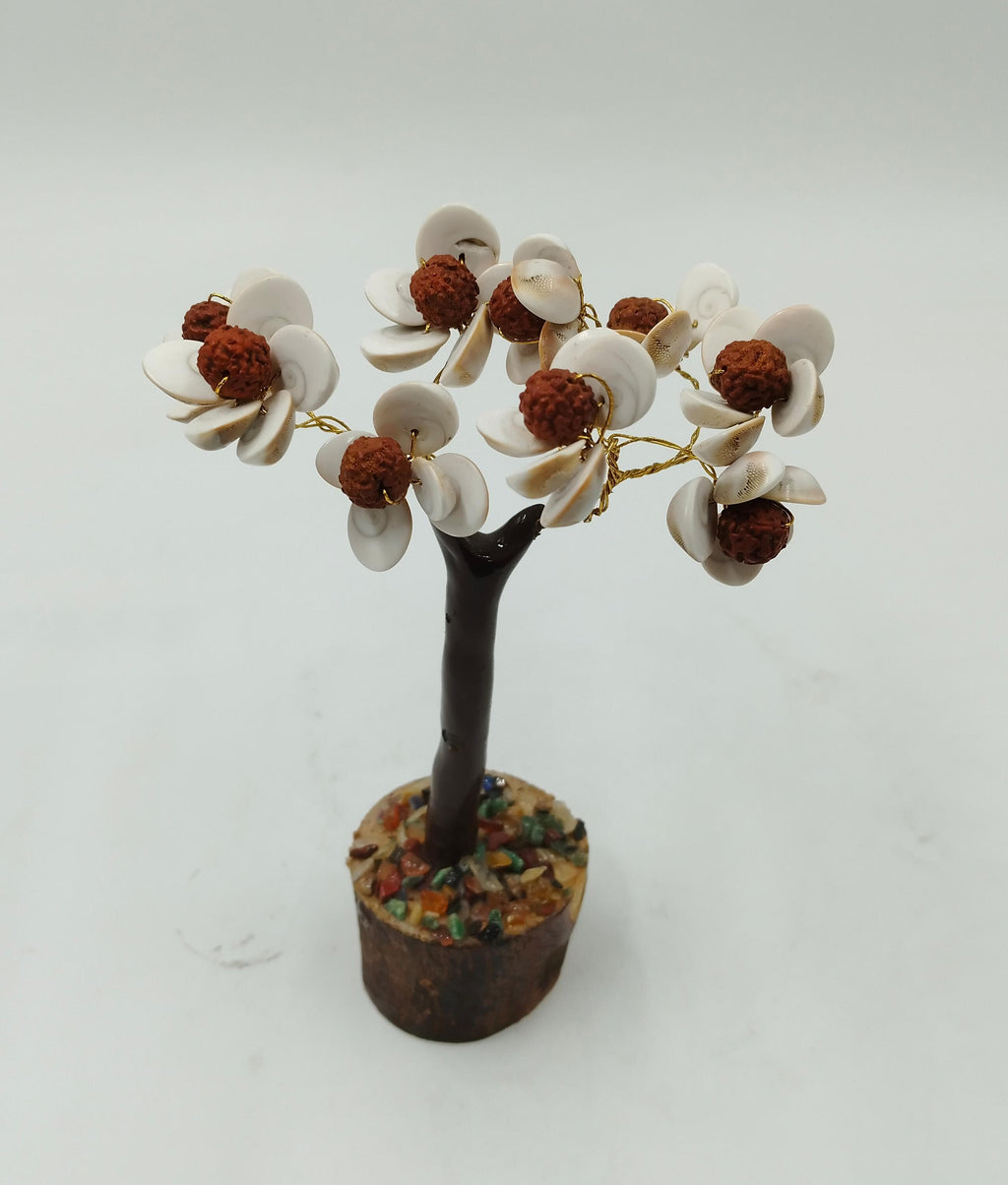 A decorative Gomati Chakara tree with Rudraksha beads, featuring a trunk, branches, and shell-like fruits on a white background.