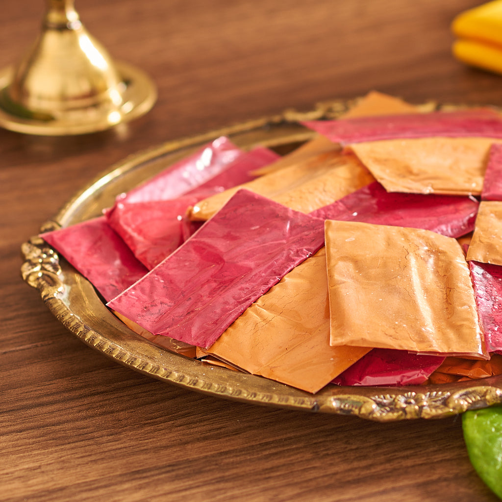 Colorful packets on a decorative tray with a blurred background