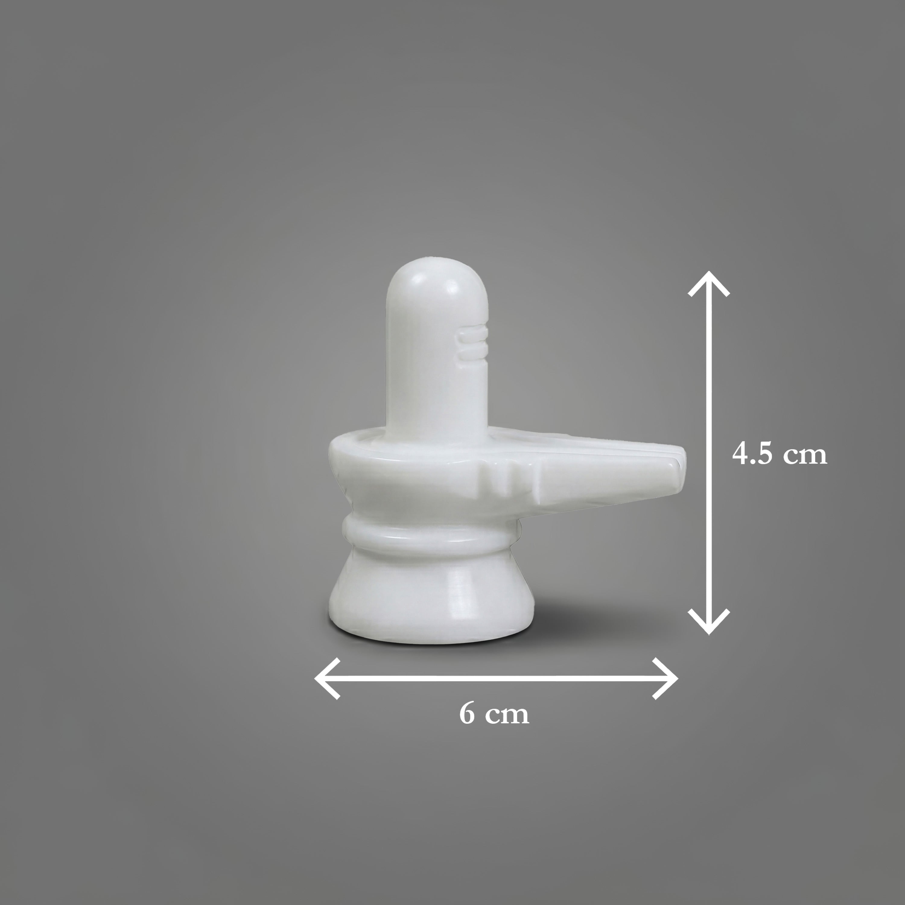 White marble Shiva Lingam with measurements on a gray background