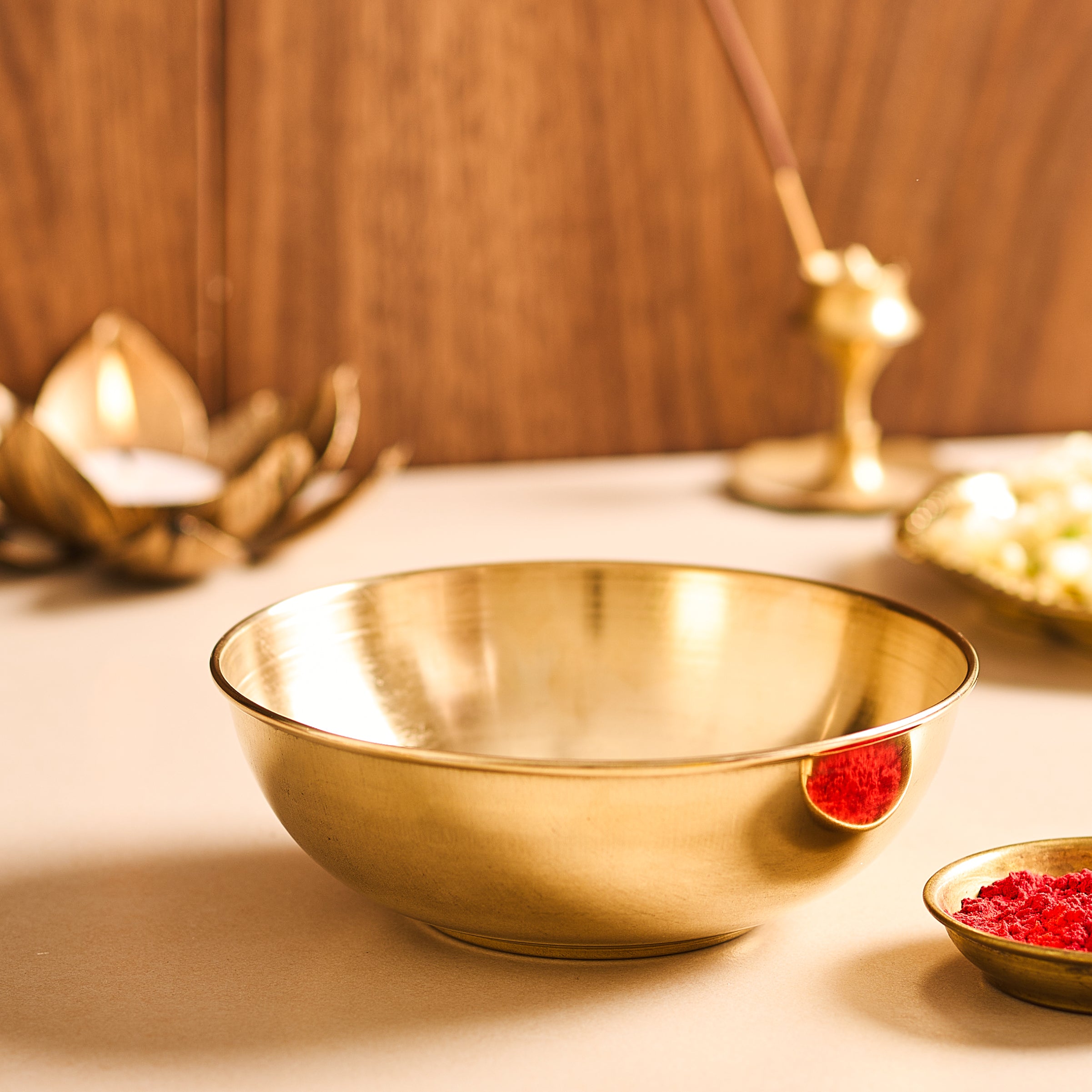 Gold bowl on a wooden surface with a blurred background