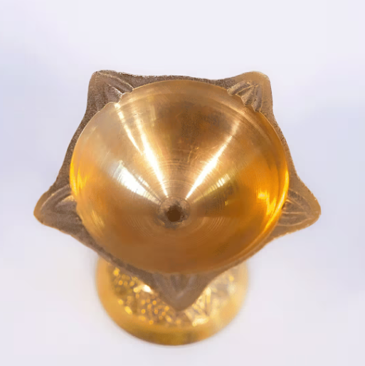 Gold-colored decorative object on a white background